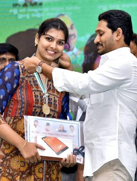 Chief Minister Y. S. Jagan Mohan Reddy presenting a medal to a girl at a programme held to mark National Education and Minorities Welfare Day, in Vijayawada on Monday.  