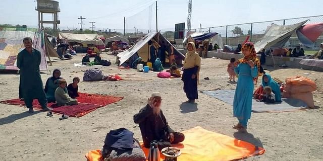 Afghan families sit outside their tents in an open area on the outskirts of Chaman, a border town in the Pakistan's southwestern Baluchistan province, Wednesday, Sept.1, 2021.